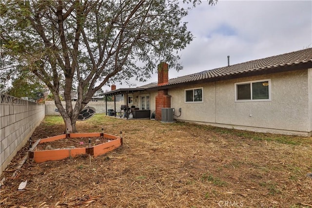 view of yard with central air condition unit, a fenced backyard, and a vegetable garden