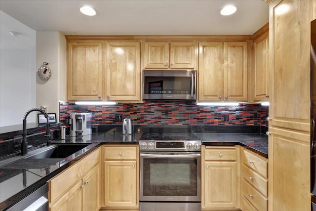 kitchen featuring sink, stainless steel appliances, tasteful backsplash, light brown cabinetry, and dark stone counters