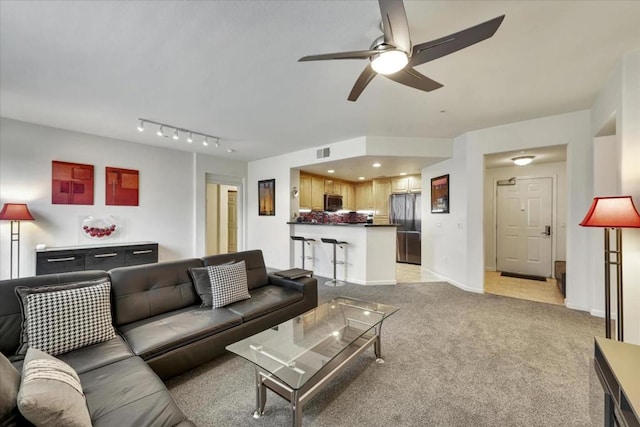 carpeted living room with ceiling fan