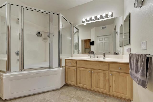 bathroom with vanity, tile patterned floors, and shower / bath combination with glass door