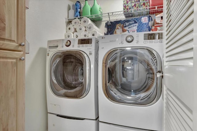 washroom with washing machine and clothes dryer