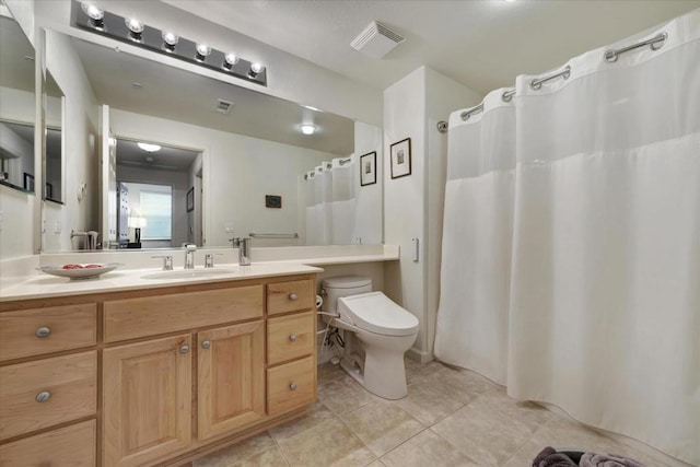 bathroom with tile patterned flooring, vanity, and toilet