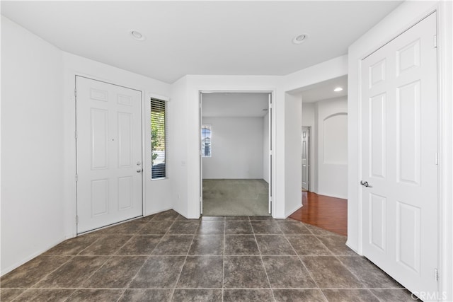 foyer entrance with dark tile patterned floors