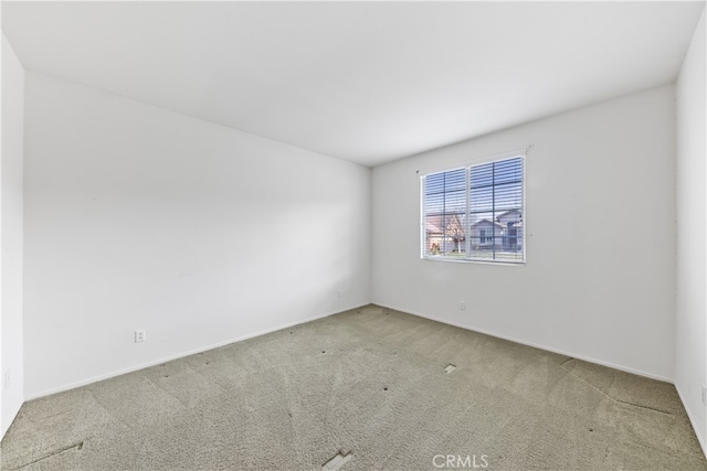 empty room featuring light carpet