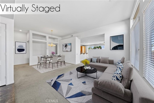 living room featuring an inviting chandelier and carpet