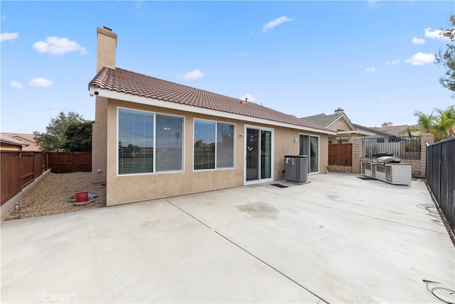 rear view of property featuring central AC and a patio