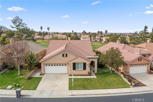 view of front of home featuring a garage and a front lawn