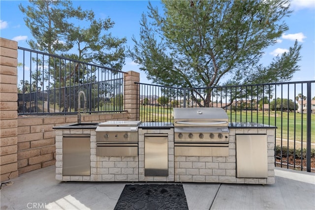 view of patio / terrace featuring exterior kitchen and grilling area