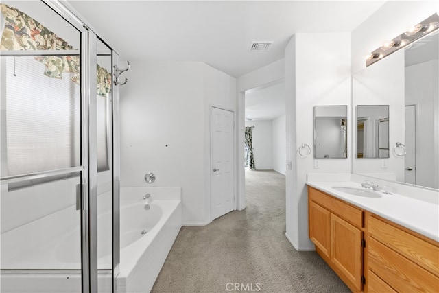 bathroom featuring vanity and independent shower and bath