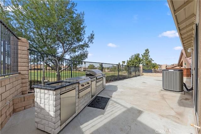 view of patio featuring central AC, grilling area, and exterior kitchen