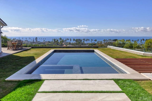 view of swimming pool featuring a water view and a yard