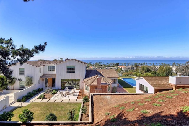 view of front of house featuring a water view and a patio area