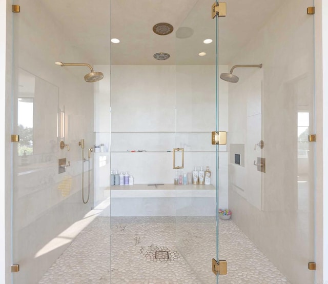 bathroom with a shower with door