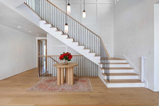 6260 Waverly Ave, La Jolla, CA 92037 - staircase with wood finished floors and a high ceiling