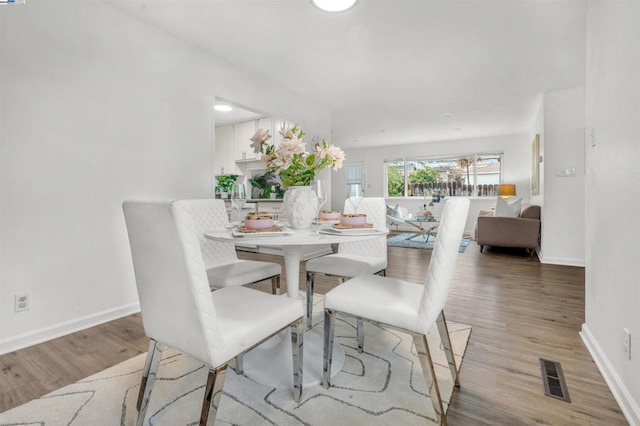 dining room with hardwood / wood-style floors