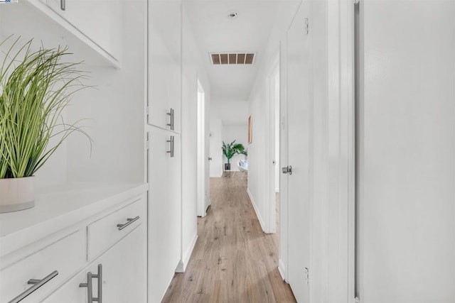 corridor with light wood-type flooring