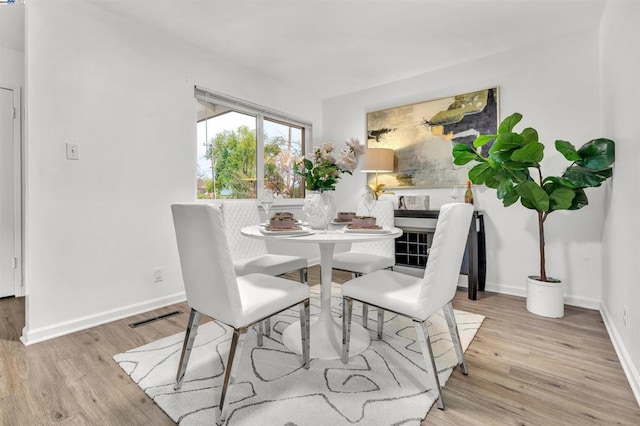 dining space featuring light wood-type flooring