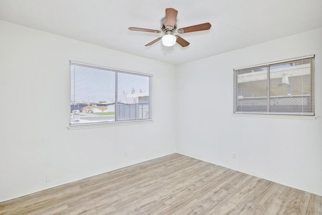 empty room featuring ceiling fan and light hardwood / wood-style floors