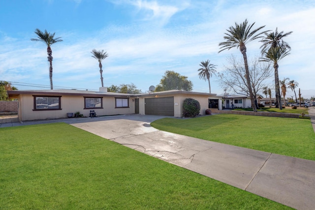 single story home with a garage and a front lawn