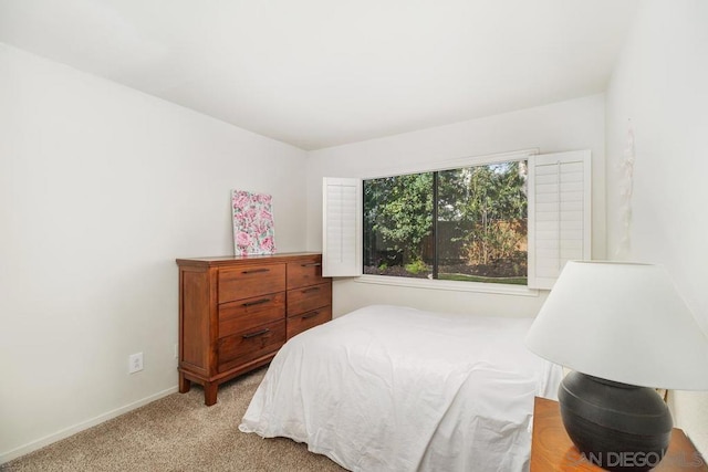 bedroom featuring light colored carpet