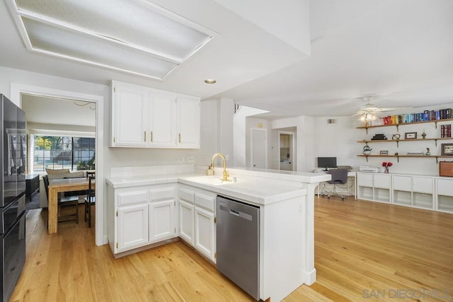 kitchen with dishwasher, sink, white cabinets, kitchen peninsula, and light hardwood / wood-style flooring