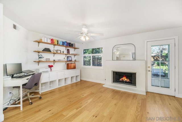 office space featuring ceiling fan and light hardwood / wood-style floors