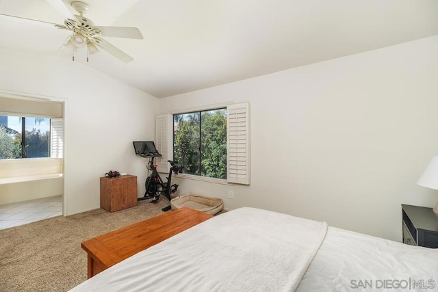 bedroom with lofted ceiling, light carpet, and ceiling fan