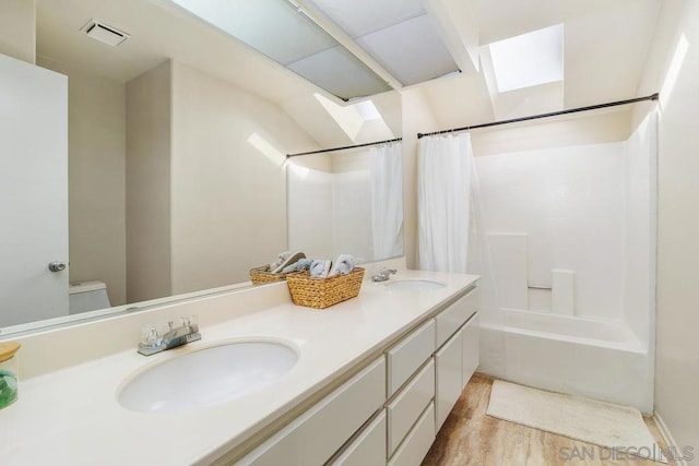 full bathroom featuring shower / tub combo, hardwood / wood-style floors, vanity, and toilet