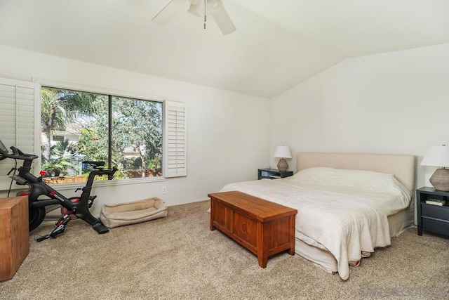 carpeted bedroom with vaulted ceiling and ceiling fan