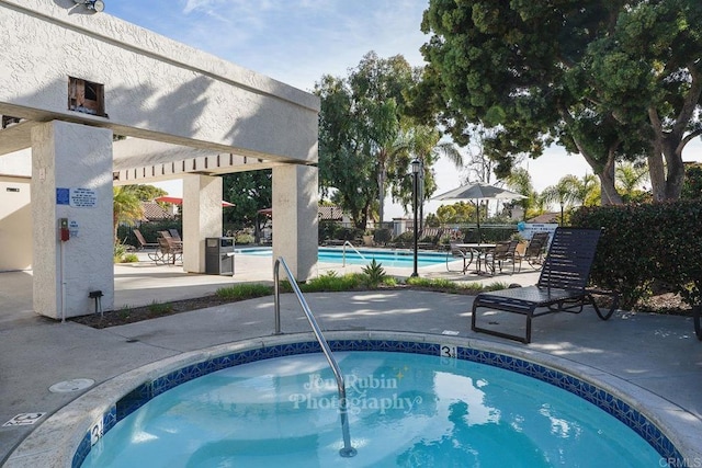 view of swimming pool featuring a pergola and a patio area