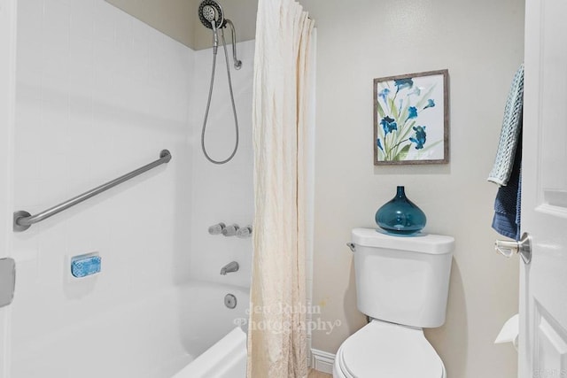 bathroom featuring toilet and shower / tub combo