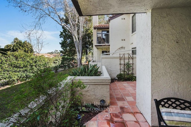 view of patio featuring a balcony