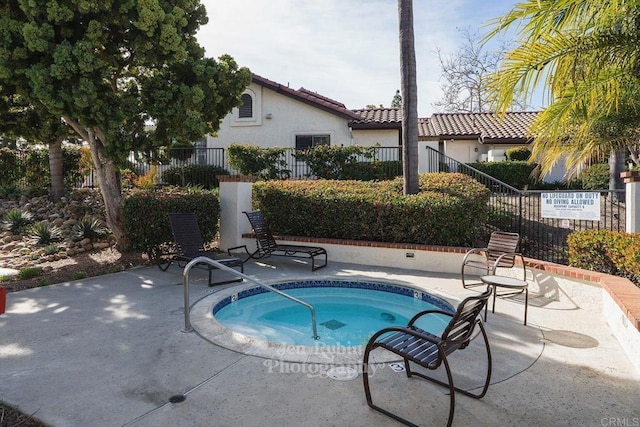 view of swimming pool with a hot tub and a patio