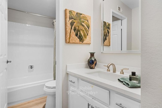 full bathroom with vanity, wood-type flooring, toilet, and shower / tub combo with curtain