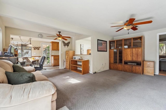 carpeted living room with ceiling fan