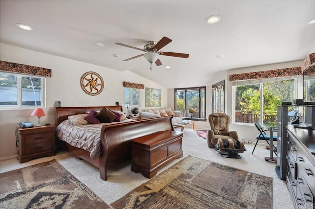 bedroom with ceiling fan, light colored carpet, and lofted ceiling