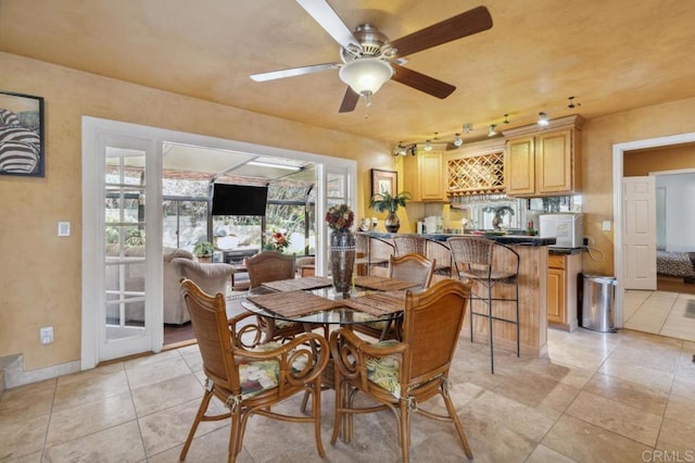 tiled dining area with ceiling fan