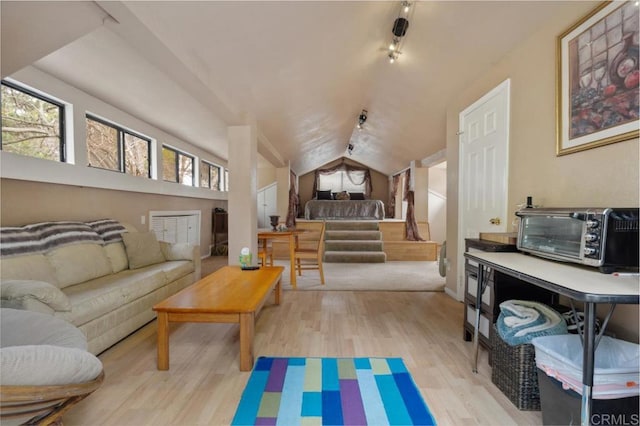 interior space with lofted ceiling and light wood-type flooring