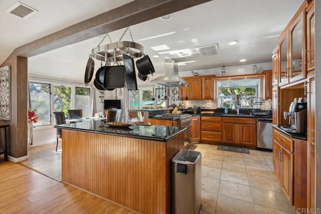 kitchen featuring sink, a center island, stainless steel dishwasher, island exhaust hood, and decorative backsplash