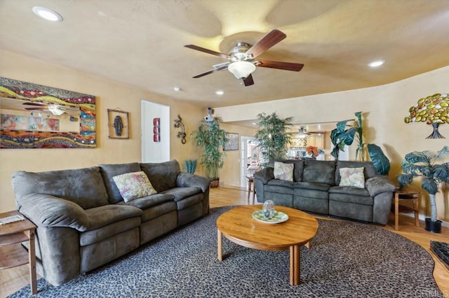 living room with hardwood / wood-style flooring and ceiling fan