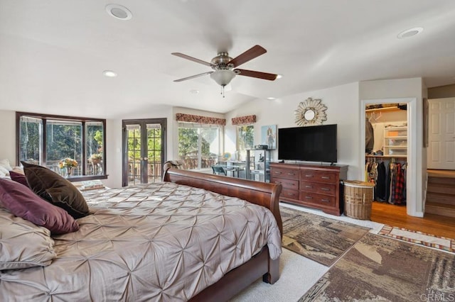 bedroom featuring french doors, lofted ceiling, a spacious closet, access to outside, and a closet