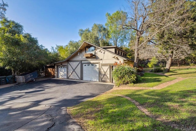 exterior space featuring a garage and a front yard