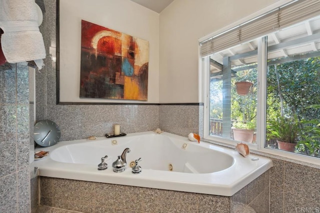 bathroom with a relaxing tiled tub