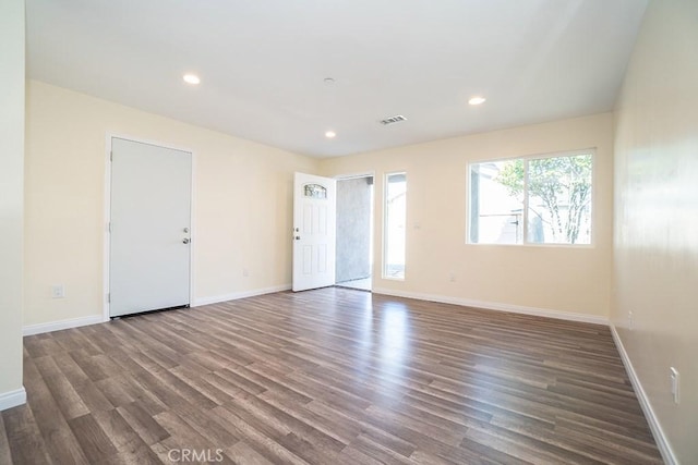 spare room with dark hardwood / wood-style floors