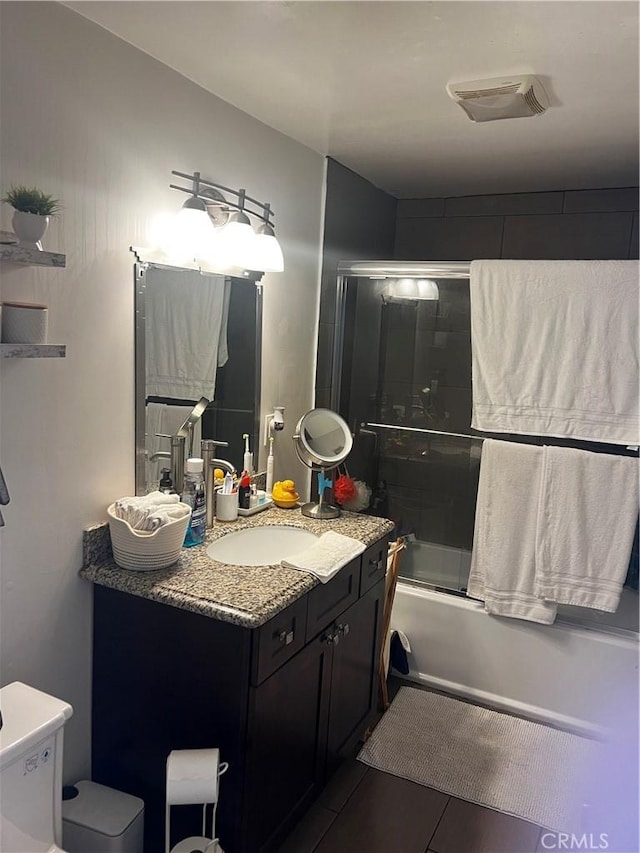 bathroom featuring vanity and combined bath / shower with glass door