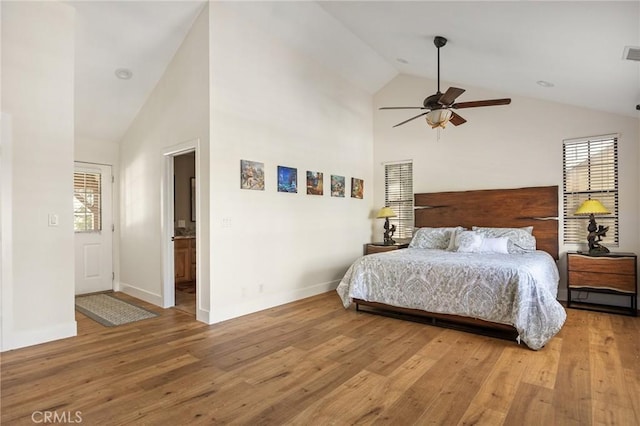 bedroom with wood-type flooring, ceiling fan, and high vaulted ceiling