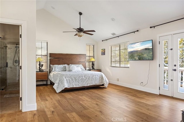 bedroom featuring multiple windows, access to exterior, light hardwood / wood-style floors, and high vaulted ceiling