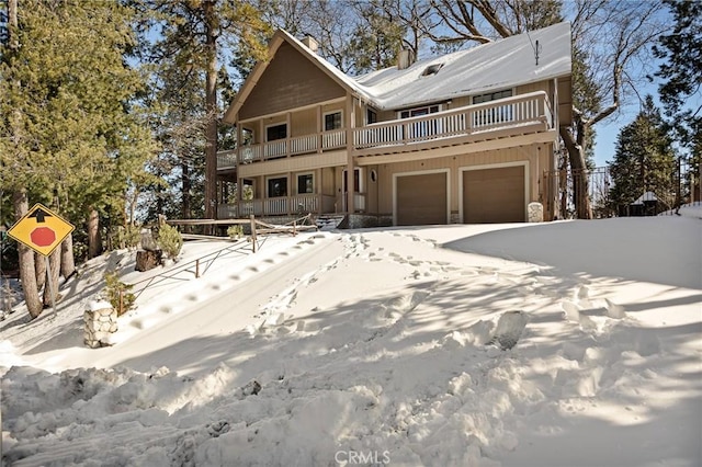 view of front property featuring a garage and a balcony