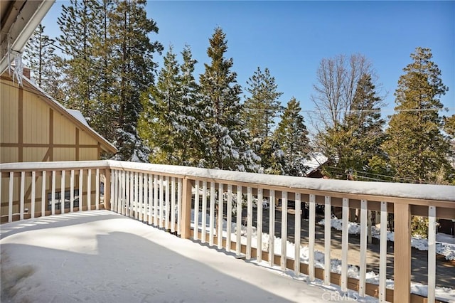 view of snow covered back of property