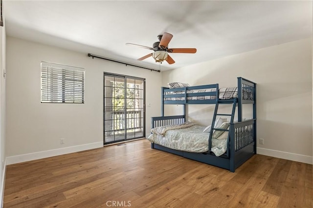 bedroom featuring wood-type flooring, access to exterior, and ceiling fan